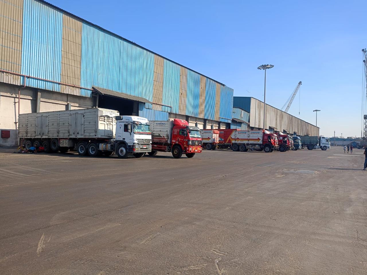 Fleet of trucks staged outside warehouse facility